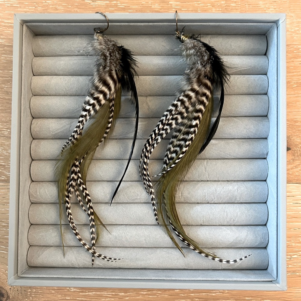 Feather dangle earrings with olive black and white coloring
